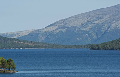 Scenic view of lake and mountains against clear sky