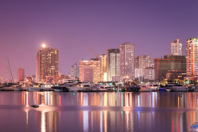 City skyline against clear sky at dusk