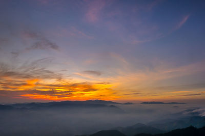 Scenic view of silhouette mountains against sky during sunset