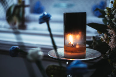 Close-up of lit tea light candle on table