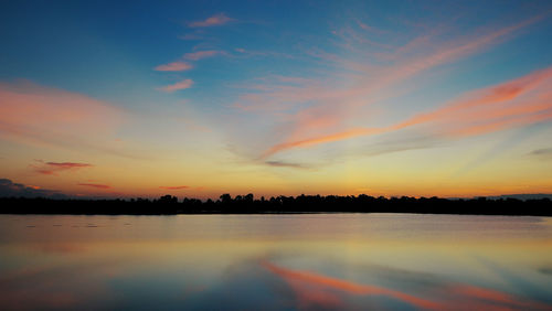 Scenic view of lake against romantic sky at sunset