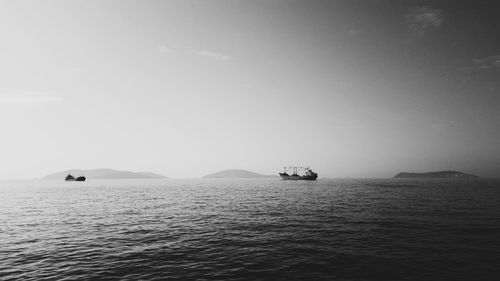 Boat sailing in sea against sky