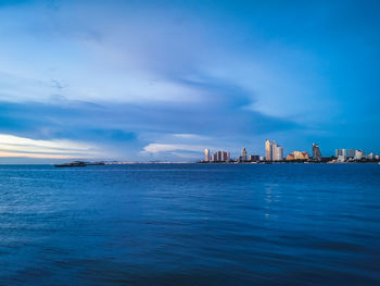 Scenic view of sea and buildings against sky