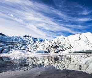 Scenic view of snow capped mountains against sky