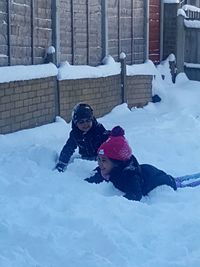 Full length of children in snow