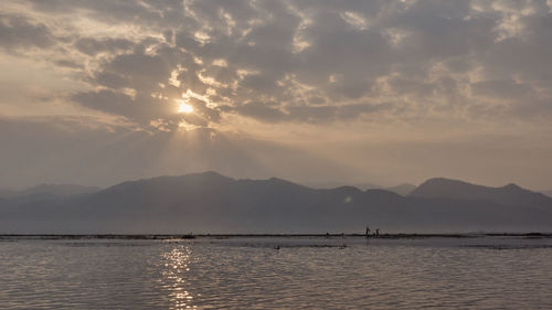 Scenic view of lake against sky during sunset