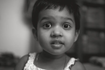 Black and white portrait of a cute baby girl with expressive face
