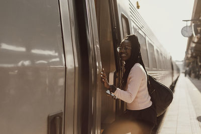 Side view of woman standing by train