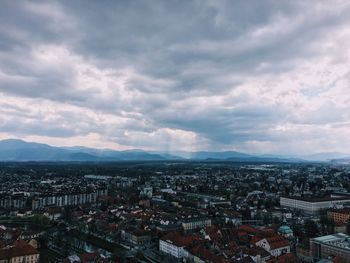 Cityscape against cloudy sky