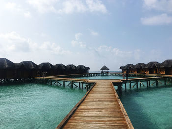 Pier over sea against sky in maldives 