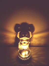 Low angle view of illuminated woman in dark room