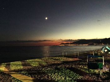 Scenic view of sea against clear sky at night