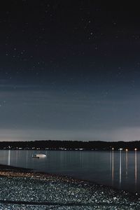 Scenic view of sea against sky at night