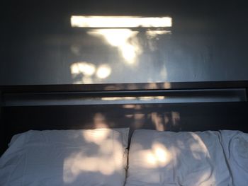 Close-up of illuminated bed at home