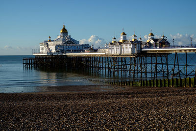 View of building by sea against sky