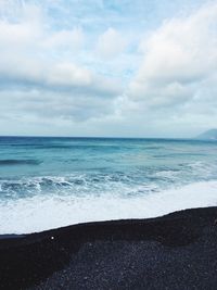 Scenic view of sea against cloudy sky