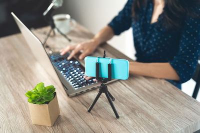 High angle view of woman using laptop on table