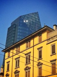 Low angle view of buildings against blue sky