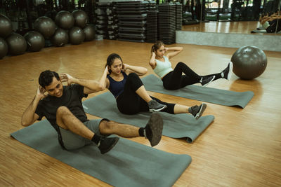 High angle view of woman exercising in gym