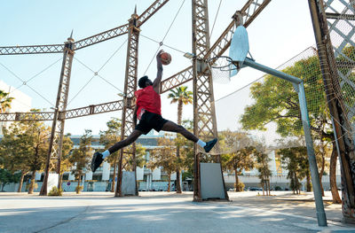 Low angle view of woman exercising on field