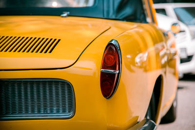 Close-up of vintage car on street