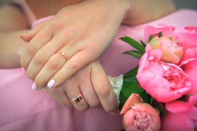 Midsection of bride holding flower bouquet