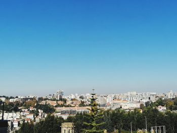 High angle view of townscape against clear blue sky