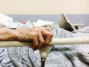 Low section of man lying on bed