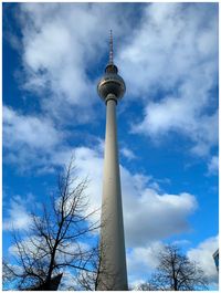 Low angle view of communications tower against sky