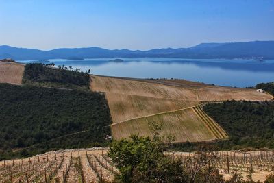 Scenic view of mountains and river against clear sky