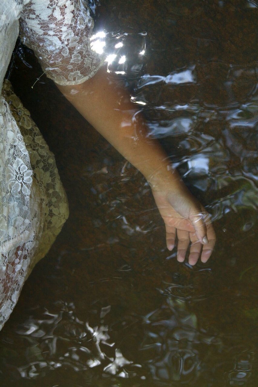 water, low section, person, high angle view, barefoot, lifestyles, reflection, leisure activity, wet, human foot, waterfront, standing, men, rippled, unrecognizable person, part of