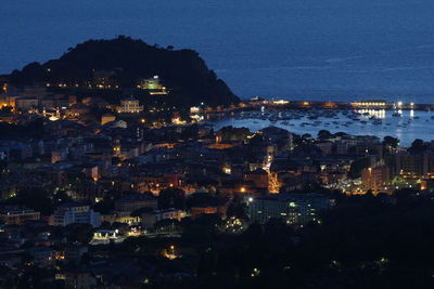 High angle view of illuminated buildings in city at night