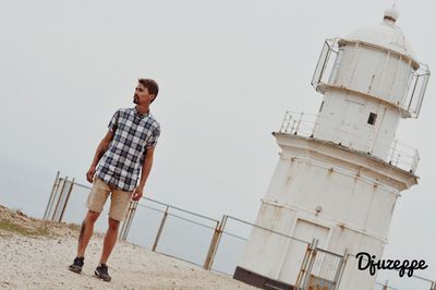 Low angle view of man standing against sky