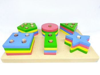 High angle view of toys on table against white background