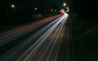 High angle view of light trails on highway at night