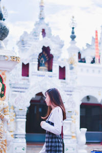 Side view of woman looking at city