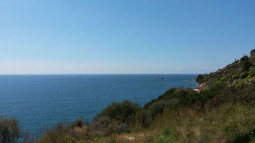 Scenic view of sea against clear blue sky