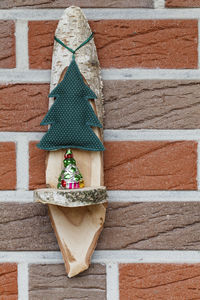 Close-up of christmas decoration hanging against wall