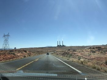 Road against sky seen through car windshield