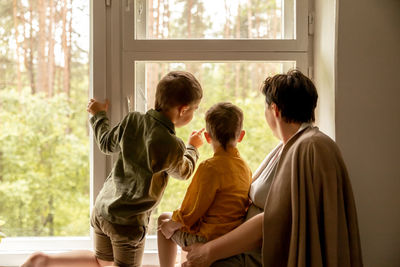 Happy grandmother and her grandsons enjoy time together. positive middle age woman 