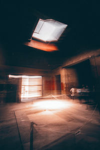 Illuminated parking lot by building at night