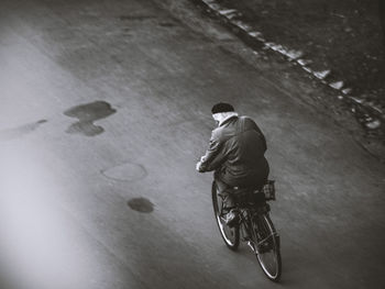 High angle view of man riding bicycle on road