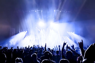 Cheering young people at a rock concert