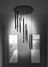 Electric lamp hanging on ceiling of building