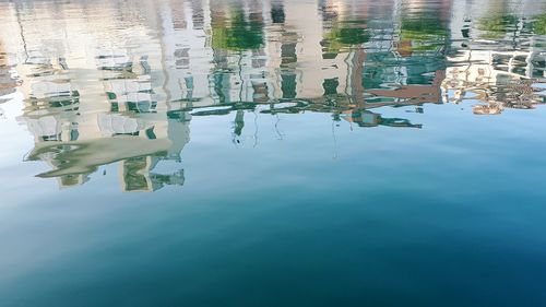 High angle view of buildings reflection in lake