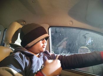 Portrait of boy sitting in car