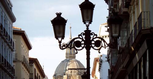Low angle view of street light against buildings