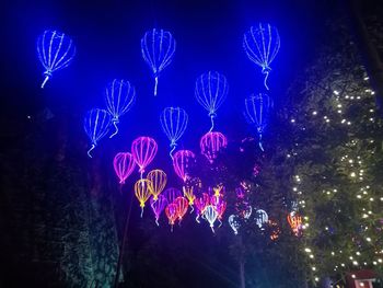 Low angle view of illuminated sky at night