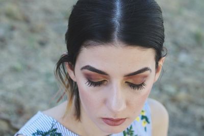 Close-up of young woman wearing make-up outdoors