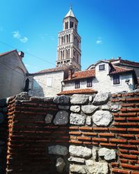 Low angle view of old building against blue sky